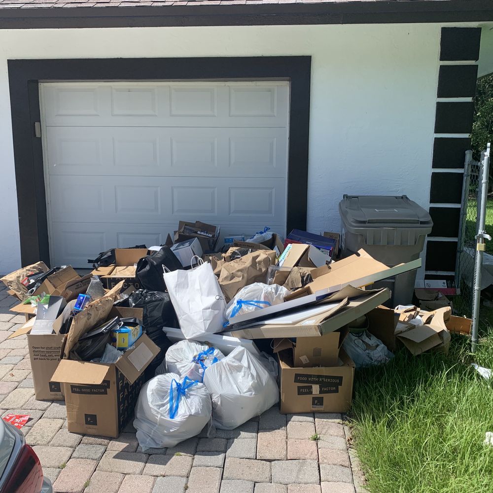 Junk and cardboard debris piled outside a home in Pantops Charlottesville