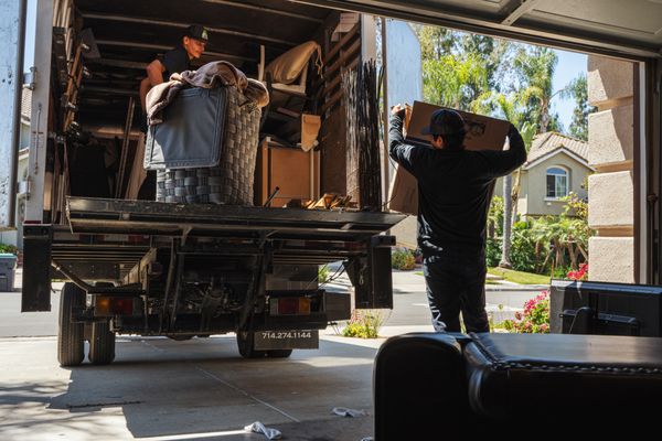 Junk removal team loading household belongings into a truck during a whole-home cleanout in Crozet, Virginia.
