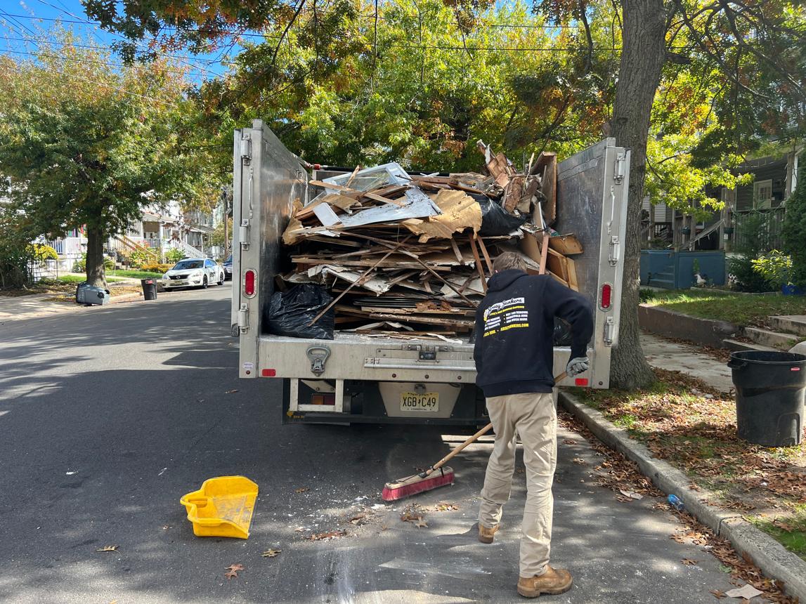 Junk removal professionals hauling renovation debris from a Downtown Charlottesville property.