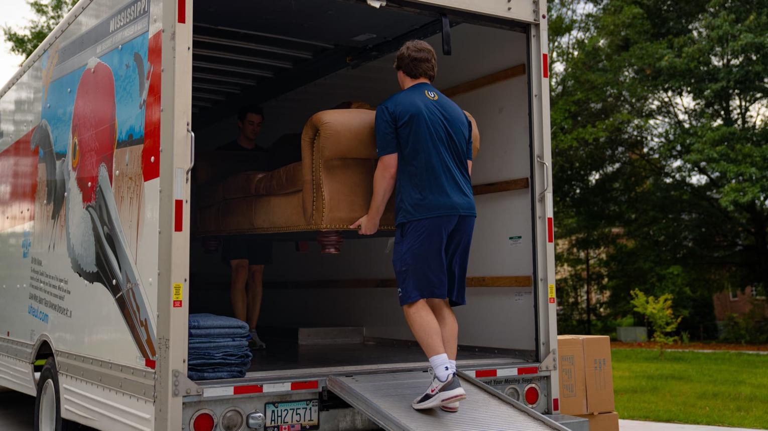 Junk removal crew collecting unwanted furniture during a UVA student move-out in Charlottesville.